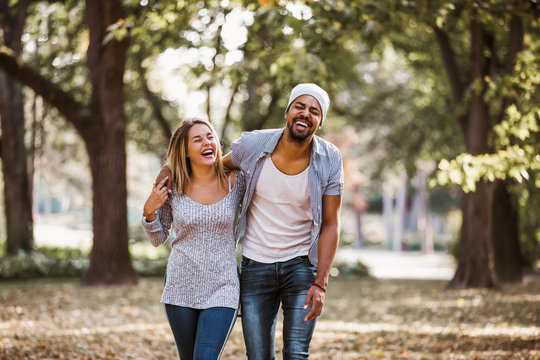 Portrait of happy mixed race couple in walking.