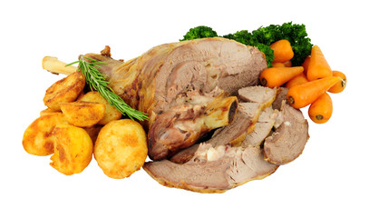 Roasted half lamb leg meat joint with roast potatoes, carrots and broccoli isolated on a white background