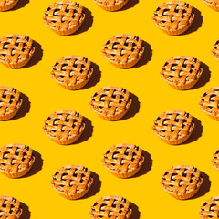Fresh baked mini cherry pie is an autumn homemade meal on yellow with hard shadows. Seamless pattern
