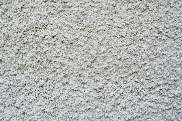 Gray cement surface as background. Part of the building facade with decorative plaster