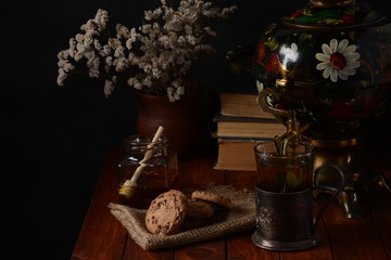 Tea Party in rustic style with samovar
a glass in glass holder, honey and cookies
