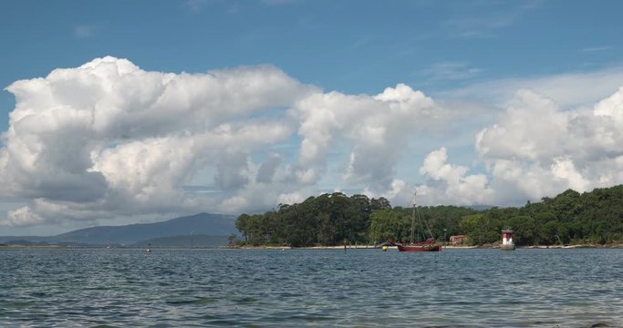 Seascape of Ria de Arousa with Traditional sailing boat on the sea and Cortegada island at background. Rias Baixas Coast on summertime. Timelapse video