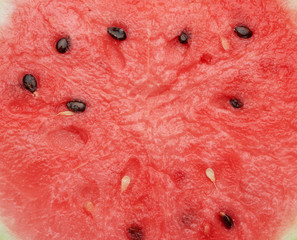 cut texture of red ripe watermelon with brown seeds