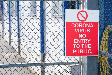 No entry to the public coronavirus covid-19 safety sign at place of work factory entrance