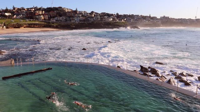 Active people swimming in rock pool of Bronte beach in Sydney as 4k.
