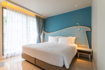 Clean white bed, blanket and pillows in room, Elegant and luxury bedroom with soft sunlight from...
