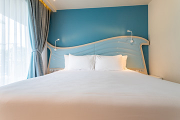 Clean white bed, blanket and pillows in room, Elegant and luxury bedroom with soft sunlight from the white curtain