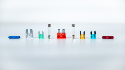 
Alignment of transparent and multicolored fuses on a white background