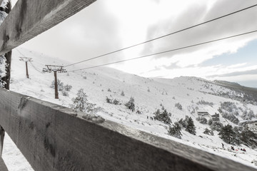 Fototapeta premium Panoramic view of snow mountains with a ski lift