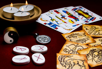 zodiac signs, astrology, runes stones, pentagram, tarot cards, candles, ying yang - like esoteric...