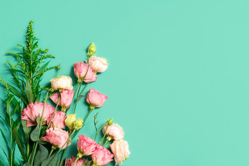 Fototapeta premium Floral composition with pastel pink roses on light green background with copy space