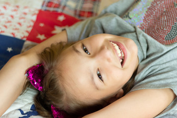 Obraz premium the girl lies on the bed and laughs