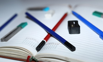 Education, Back to School, Pencil sharpener, pencil, eraser on top of notebook.