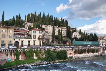 View of Lungadige Re Teodorico at historic centre of Verona. Colorful facades of old houses on...