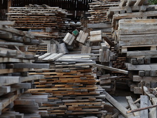 Wooden pallets and board blanks stacked in stacks. Street warehouse at the sawmill.