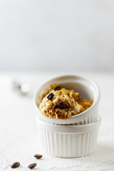 Homemade coffee ice cream from aquafaba in a white bowl. Sugar, lactose, gluten free.
