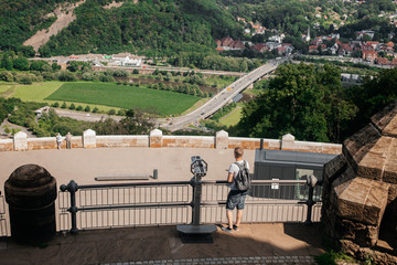 A scenic view of a valley and road from a high observation point.