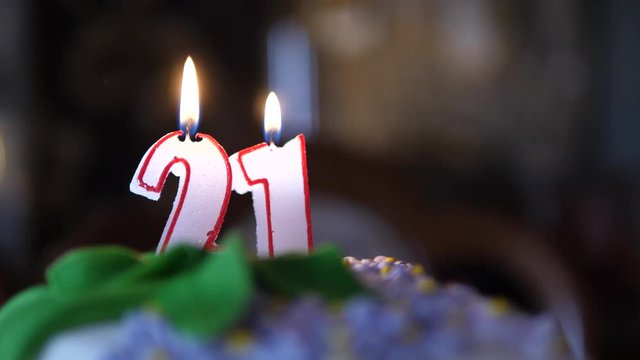 21 Birthday cake. Candles number twenty one burning. Dolly move isolated close up.
