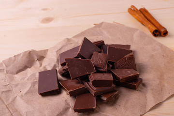 pieces of dark cocao chocolate on rustic surface