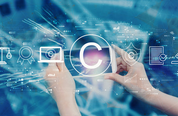 Copyright concept with person using a smartphone