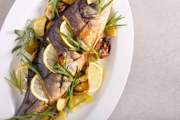 Baked sea bass fish with tarragon and lemon