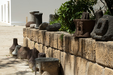 Carthage Tunisia,  row of stone objects displayed along a low wall at the roman ruins of Byrsa