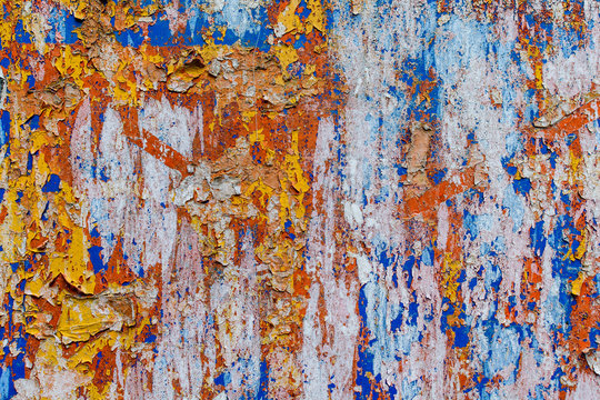 Minimalist colourful textured background of old and rusted whit, blue, brown and orange paing on metallic surface, in direct sun light in an urban environment. © Cristina Ionescu