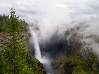 Fototapeta na wymiar Mystic foggy day at the Helmcken Falls in the Well Gray Provincial Park, British Columbia Canada.