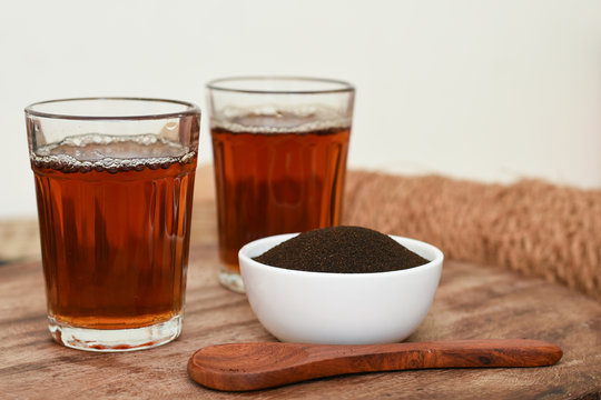 Indian Masala Chai black tea and tea dust,traditional beverage with or without milk and spices Kerala India. Two cups of organic ayurvedic or herbal drink India, good in winter for immunity boosting.