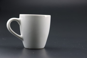 Empty white coffee cup on black color background