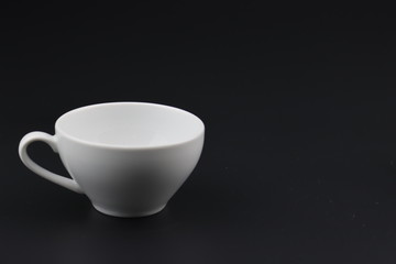 Empty white coffee cup on black color background
