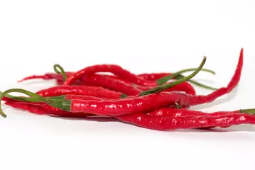 Fotobehang red chilies on a plate with a white background © Usman