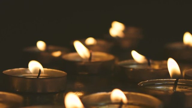 Candles light close up Christmas Midnight Mass. Dark background