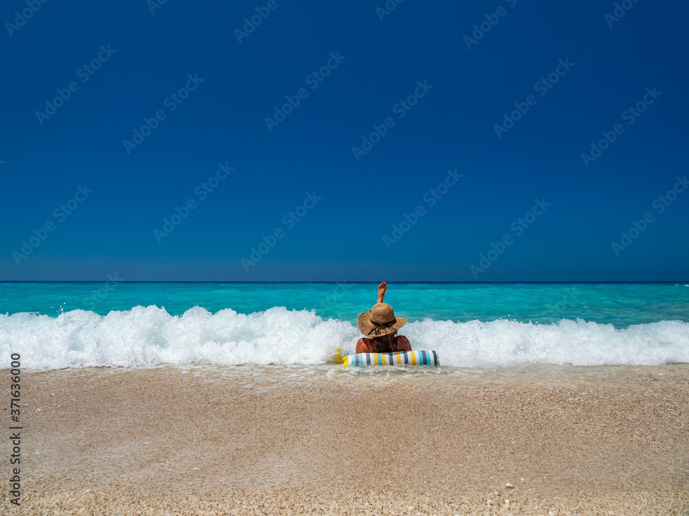 Poster woman at the beach in greece