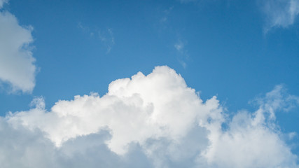 Naklejka na ściany i meble Big white cloud in a blue sky
