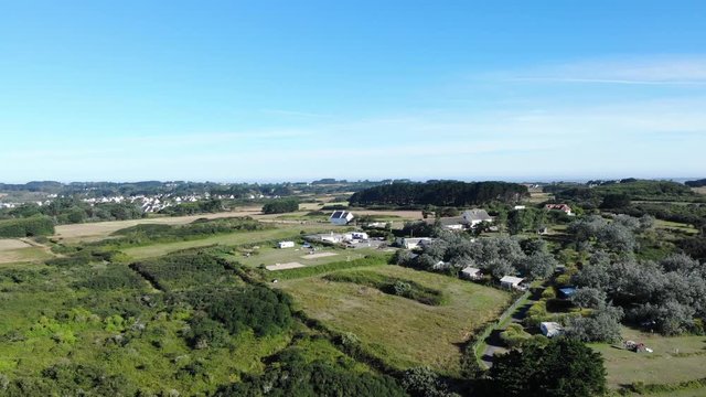 cinematic aerial drone shot of Groix island. few kilometres off the coast of Lorient. Several ferries a day run from Lorient to Groix. wonderful, touristic, and traditional place in Bretagne,