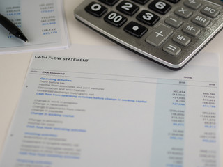 Financial statement concept:Cash flow statement paper sheet with calculator and pen.