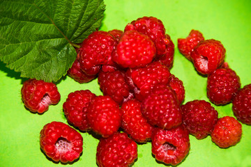raspberries on a green background