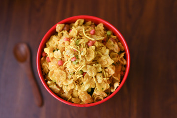 Chivda or cornflakes mixture or Farsan, traditional Indian Deep fried salty sanck made of gram flour and mixed with dry fruits, peanuts, rasins. Mix Namkeen is a spicy Diwali festival snack. 