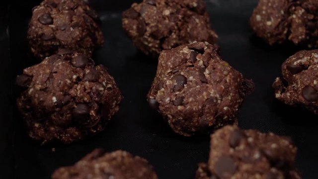 Raw dough balls of chocolate chip oatmeal cookies, Closeup Pan Left