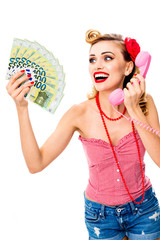 Happy excited, surprised woman holding money euro cash banknotes, talking on phone, dressed in pin up style. Girl with cheerful open mouth in retro vintage concept. Isolated over white background.