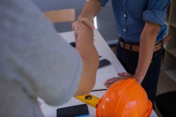 Engineers are handshake with architects to agree on a residential construction project.concept