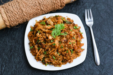 Egg Kothu Parotta a popular South Indian street food in Kerala made with shredded Porotta, a Indian...