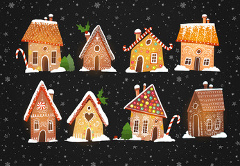 Fototapeta na wymiar Set of cute gingerbread houses with christmas decorations on black backrground