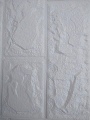 A close-up of the structure of a white plastic wall with an arbitrary pattern.