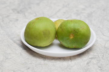 Praecitrullus fistulosus comonly known as Indian Squash, round melon, apple gourd. Called Tinda or Kundru.Fresh health vegetable fruit used for cooking curry. On white background