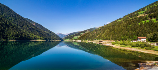 Fototapeta na wymiar Zoccolo Lake wide landscape, Santa Valburga, Italy