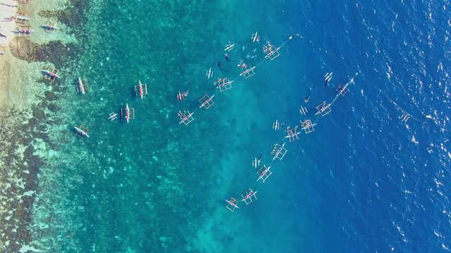Picturesque beautiful zom in top down view of whale shark watching. Turquoise sea water, calm small waves and tourist having closed fun encounter with the big fish