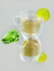 A cup of tea with lemon and mint leaf