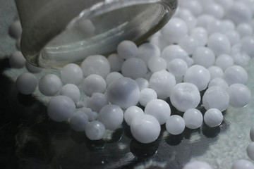 Spherical ammonium nitrate was poured from a test tube, a popular nitrogen fertilizer in...